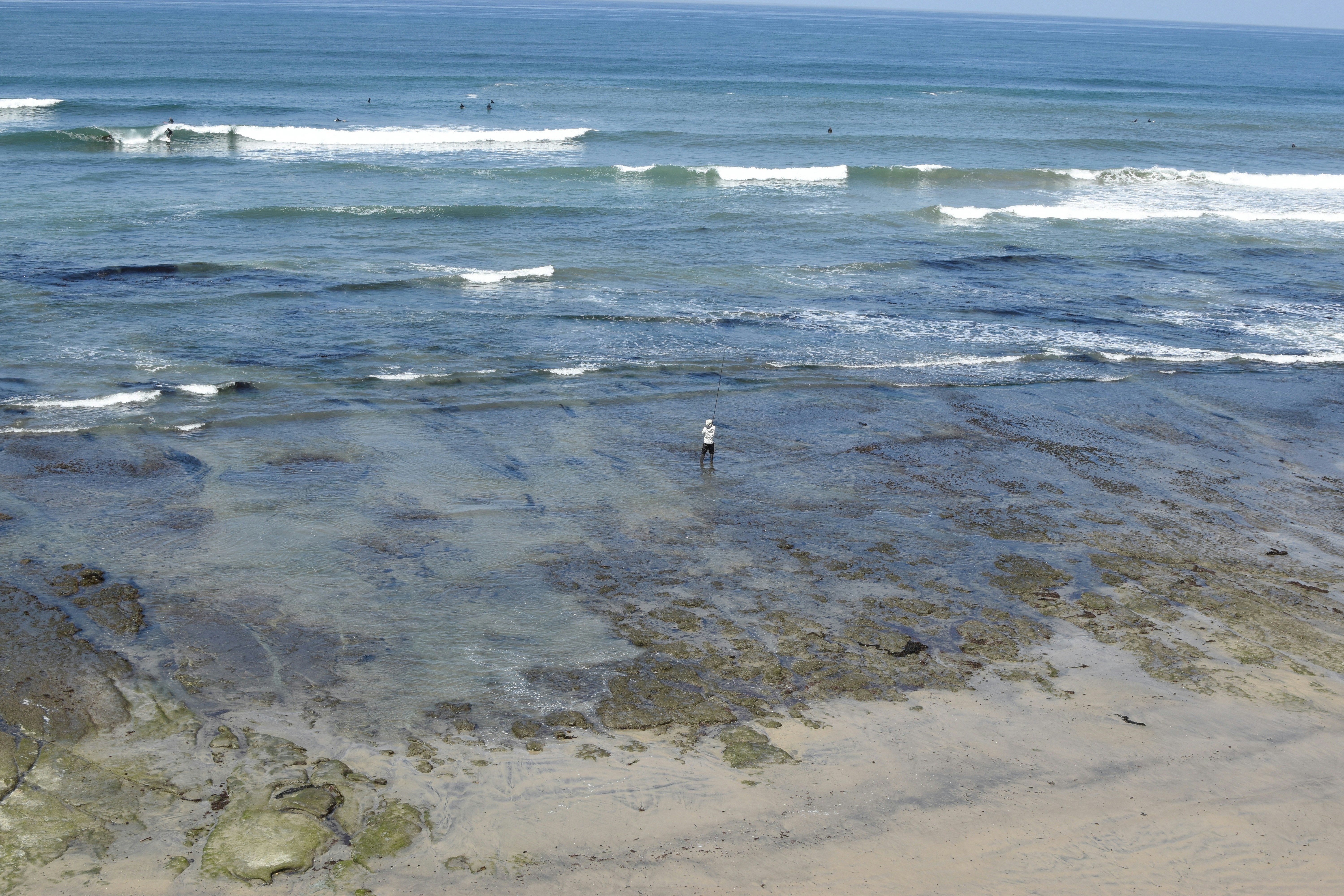 a person standing on a beach next to the ocean