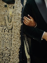 a man in a tuxedo holding a woman's hand