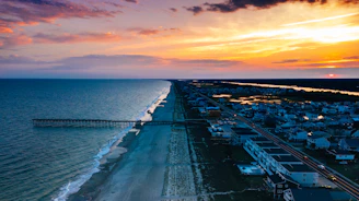 an aerial view of a beach at sunset