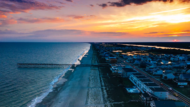 an aerial view of a beach at sunset