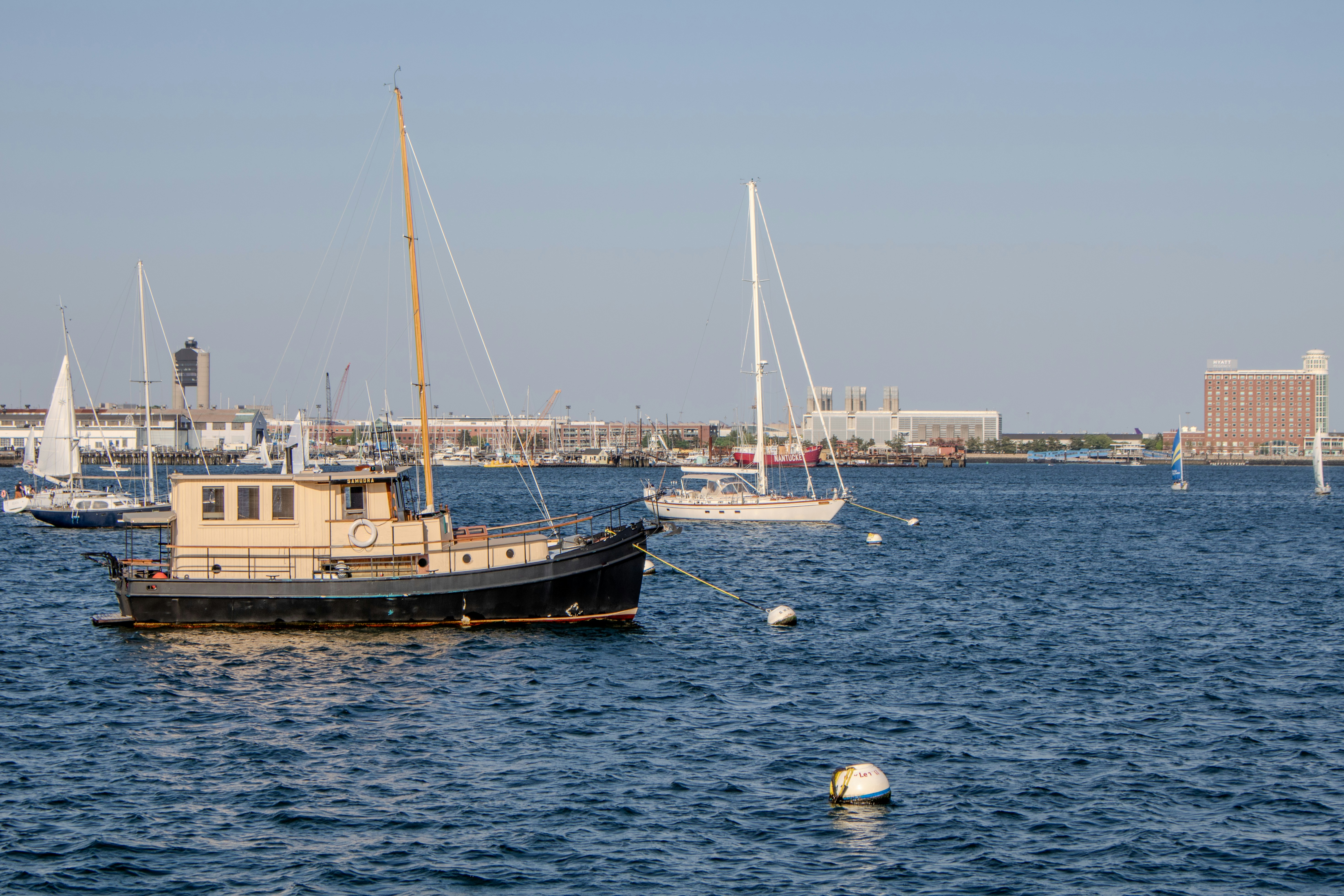 a boat floating on top of a large body of water, Boats in Boston