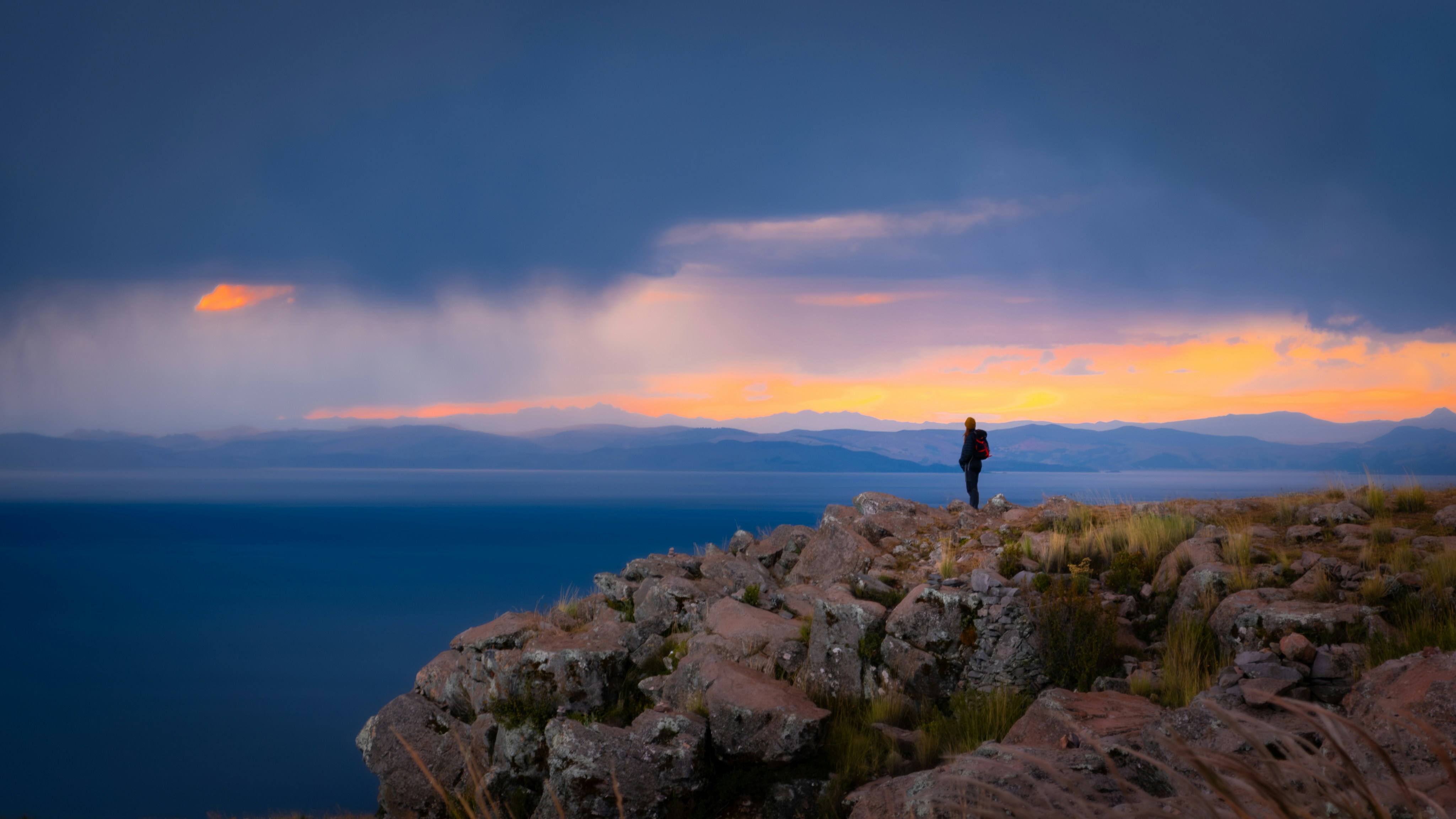 a person standing on top of a rocky cliff