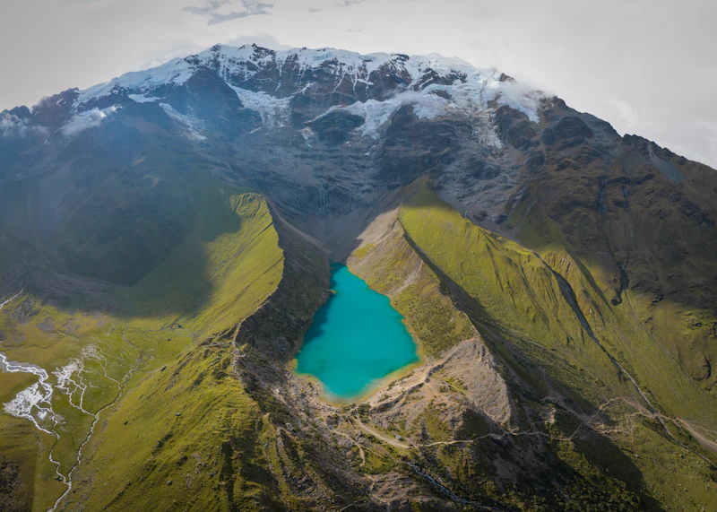 The emerald-green glacial Humantay Lake ringed by snow peaks on the Salkantay trek
