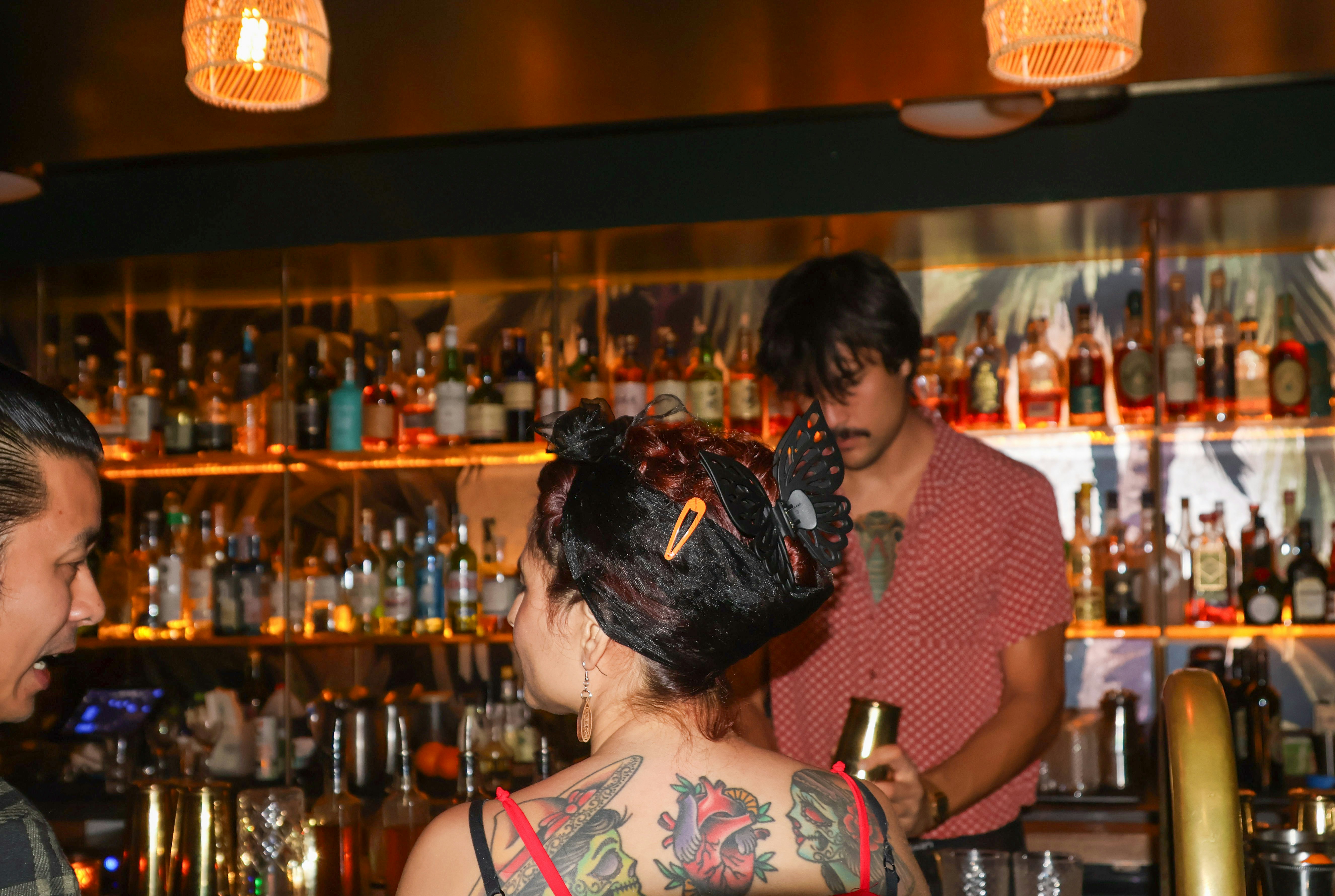 a group of people standing around a bar