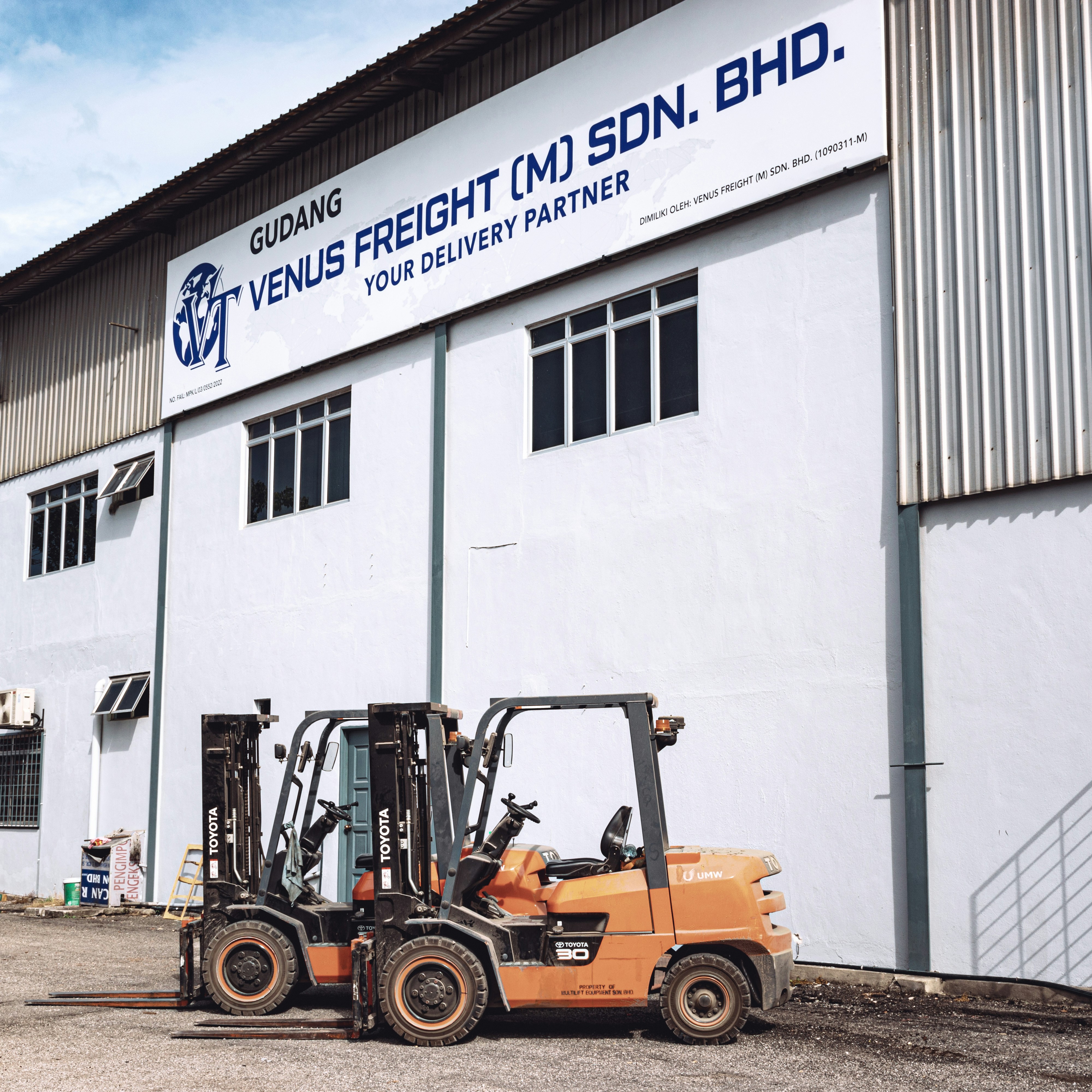 a forklift parked in front of a building