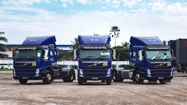 a couple of blue trucks parked next to each other