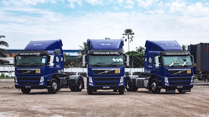 a couple of blue trucks parked next to each other