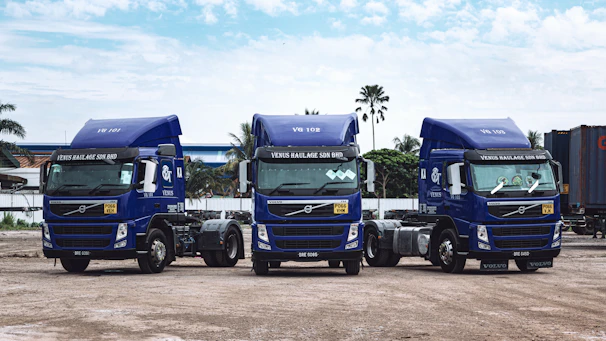 a couple of blue trucks parked next to each other