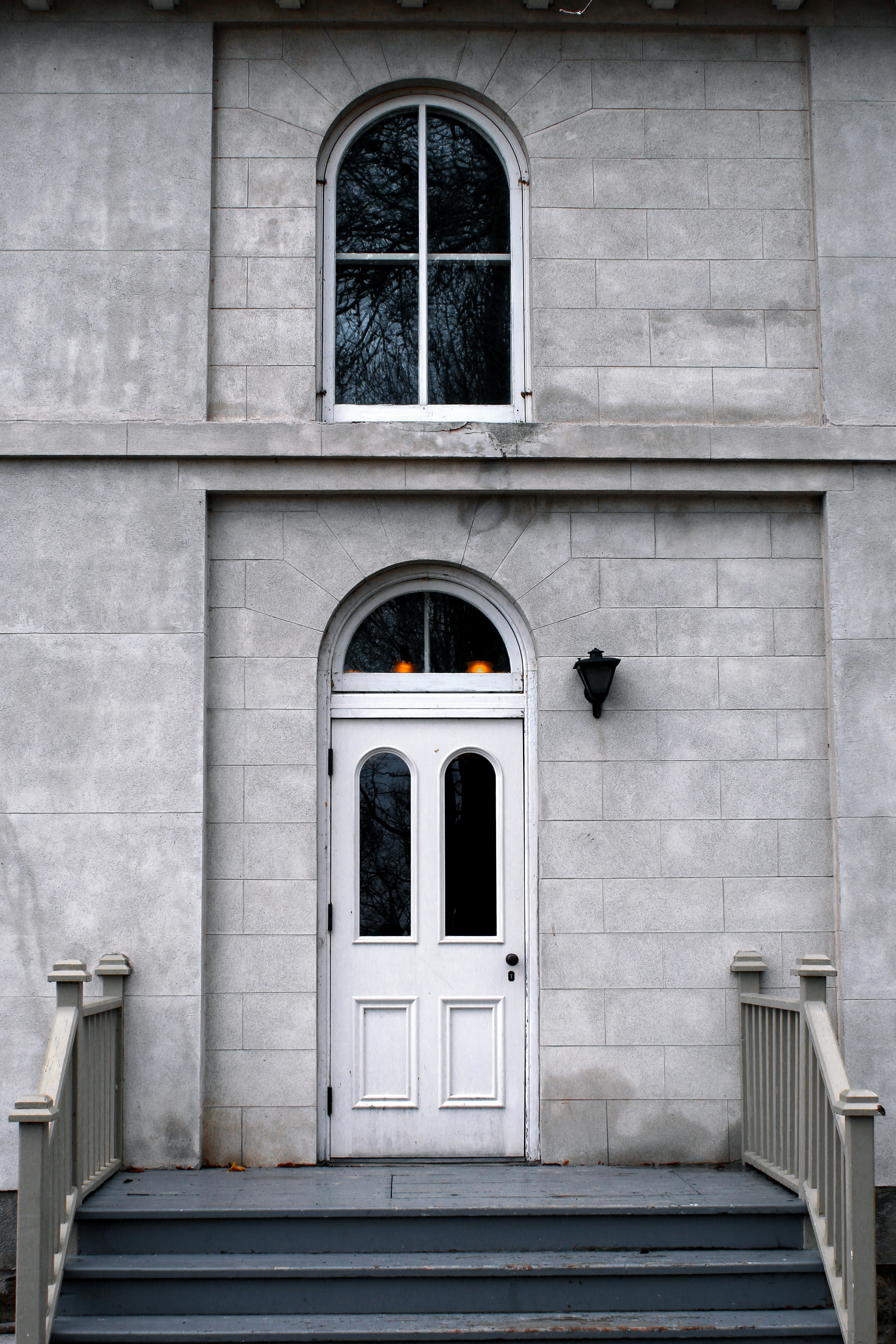 a white door and steps in front of a building