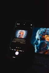 a cell phone sitting on top of a laptop computer