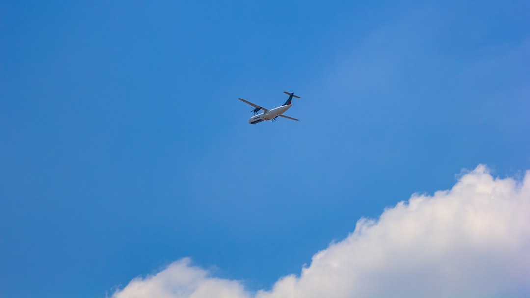 an airplane is flying in the blue sky, US-Bangla Airlines ATR 72-600 flying