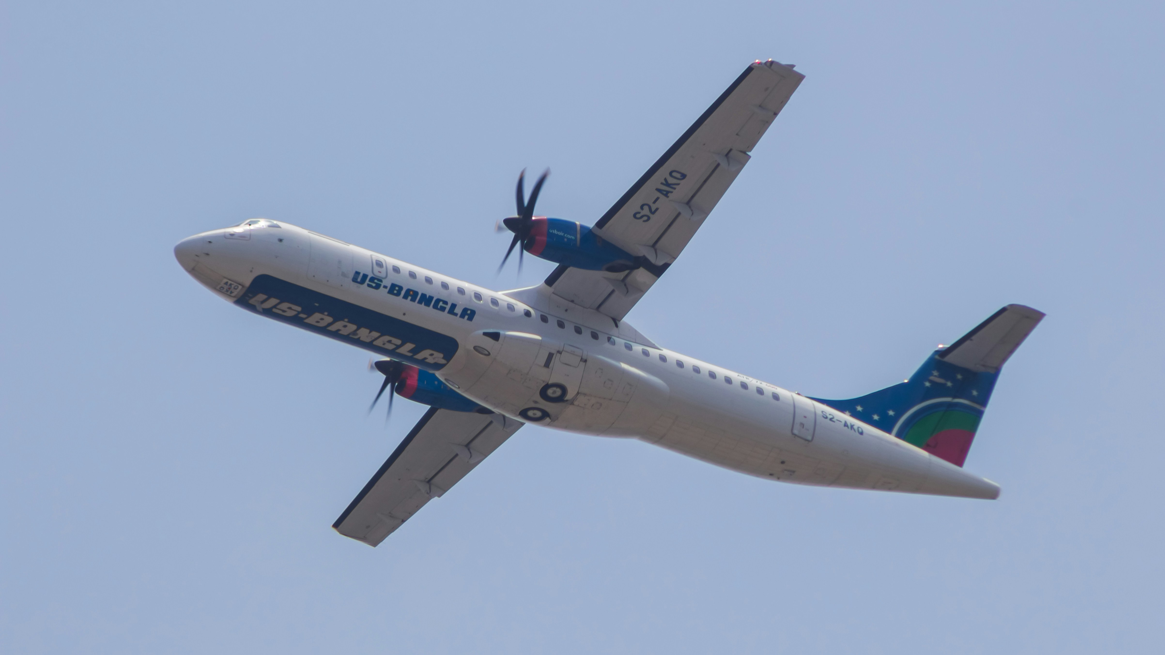 a large passenger jet flying through a blue sky, US-Bangla Airlines ATR 72-600 flying