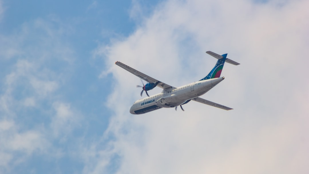 an airplane is flying in the sky on a cloudy day, US-Bangla Airlines ATR 72-600 flying