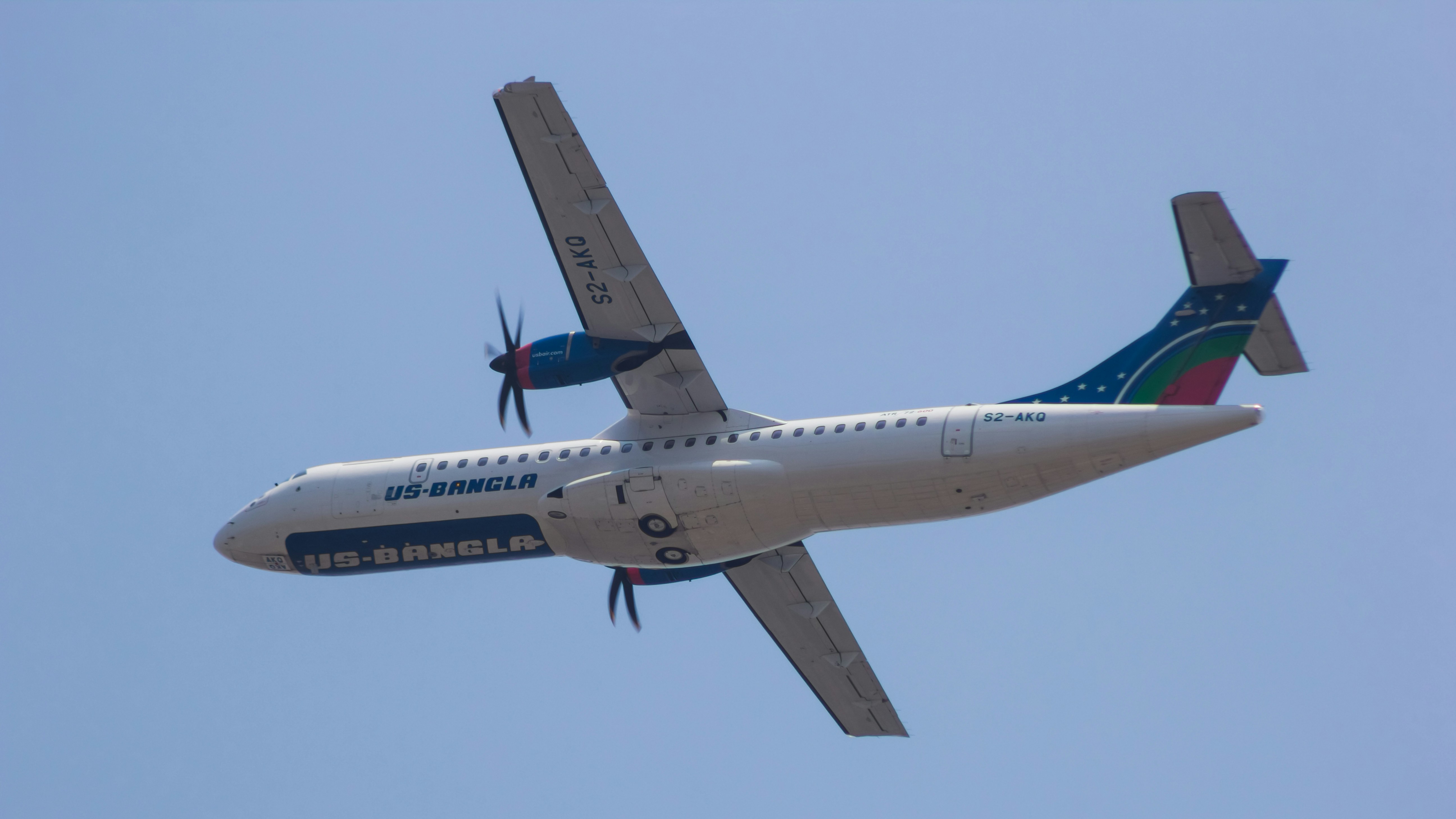 a large passenger jet flying through a blue sky, ATR 72-600 | US-Bangla Airlines