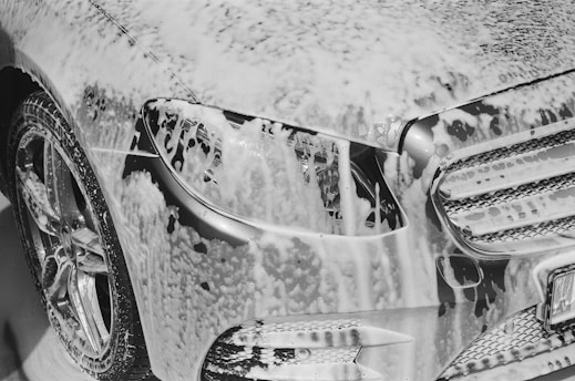 a close up of the front of a car covered in snow