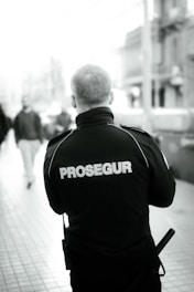 a man walking down a street with a police uniform on