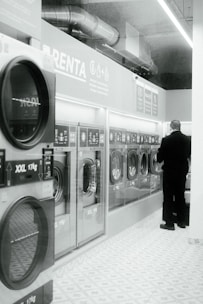 a man standing in front of a row of washing machines