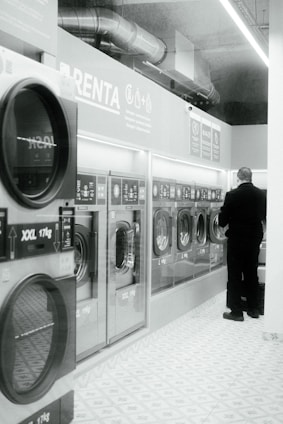a man standing in front of a row of washing machines