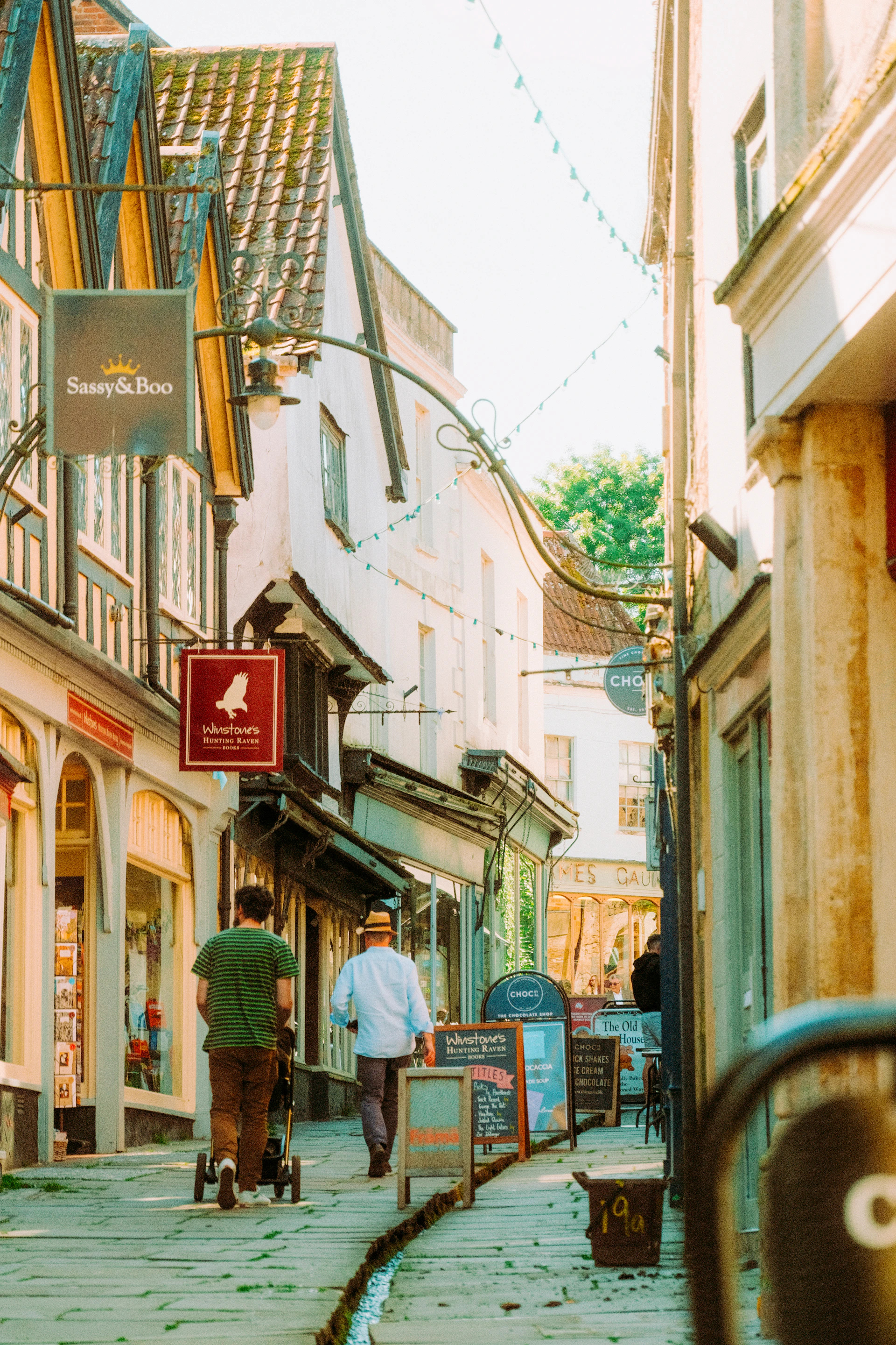a couple of people walking down a street