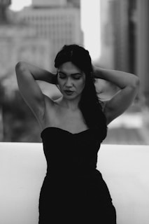 a black and white photo of a woman in a dress