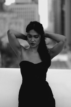 a black and white photo of a woman in a dress