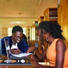 a couple of people that are looking at a laptop