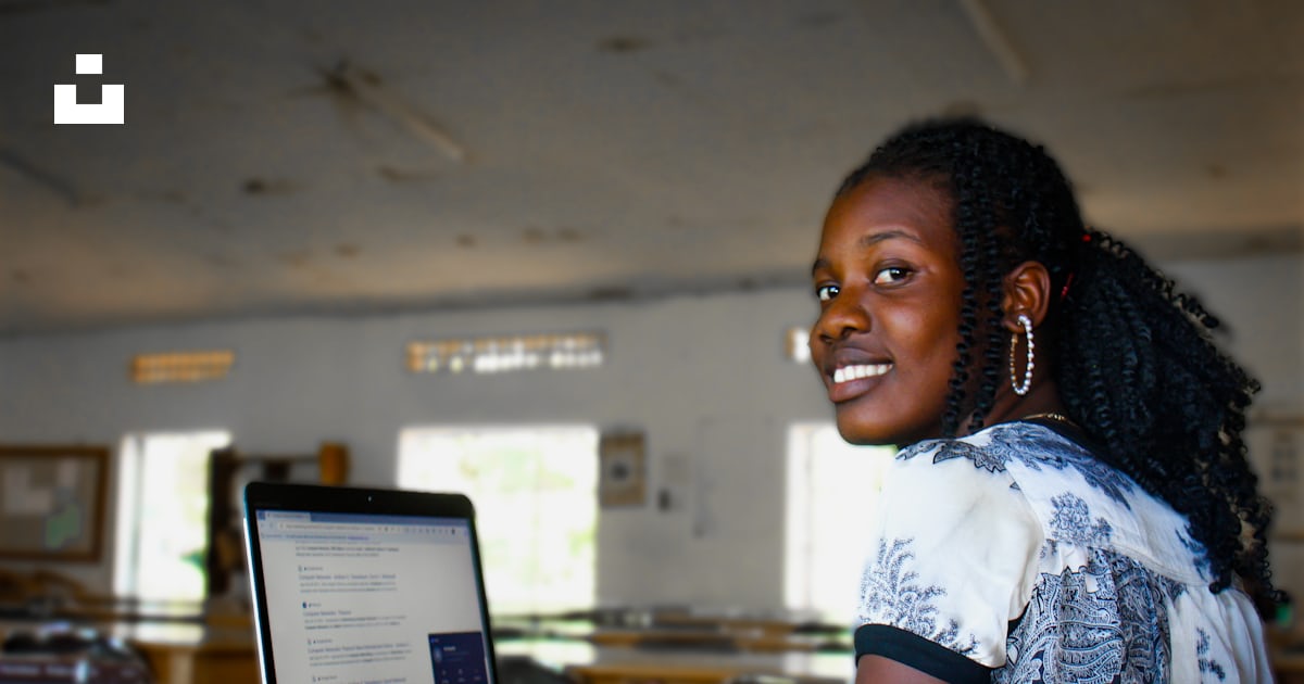 A woman sitting in front of a laptop computer photo – Free Lady Image ...
