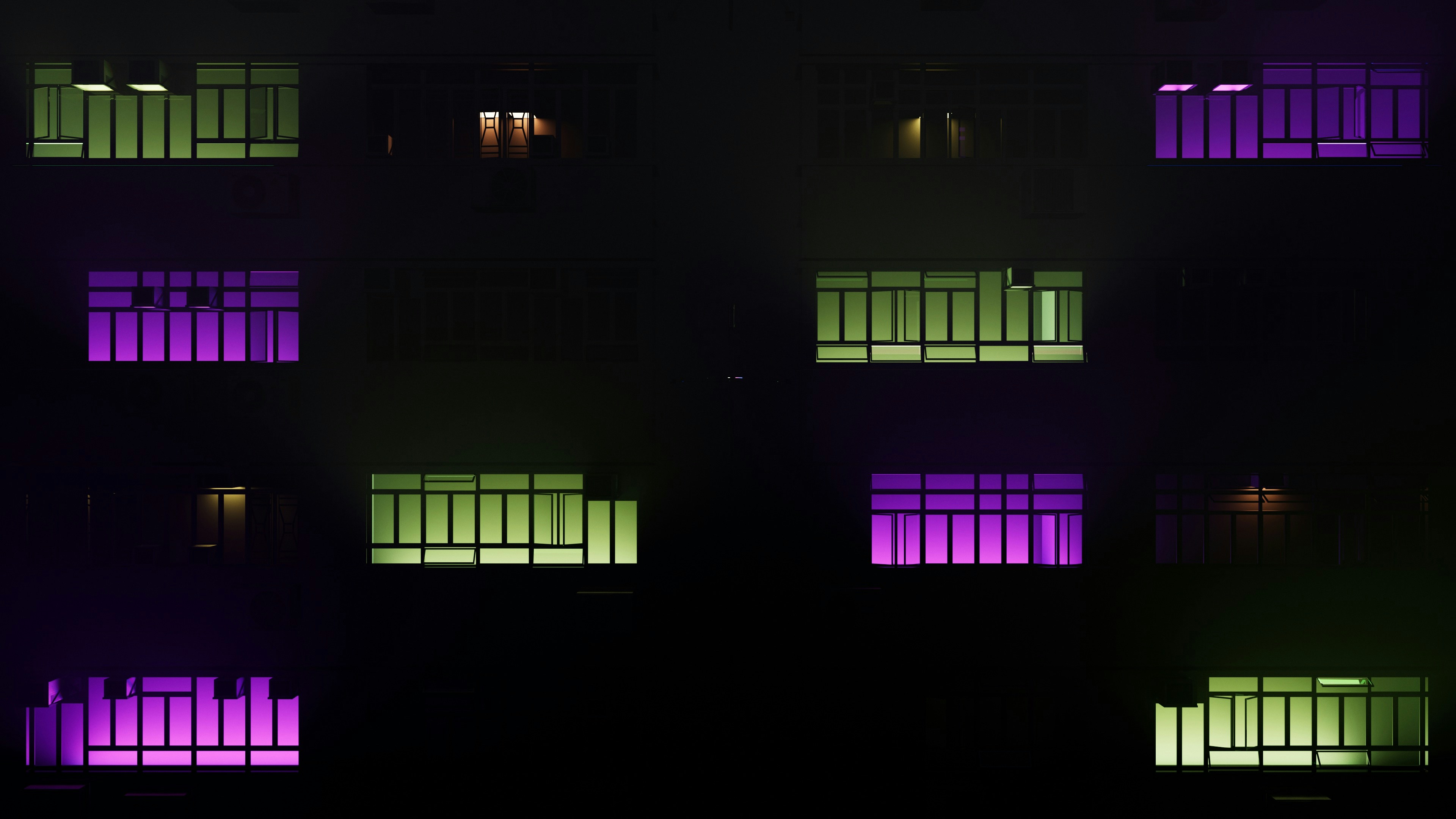 a building lit up with purple and green lights