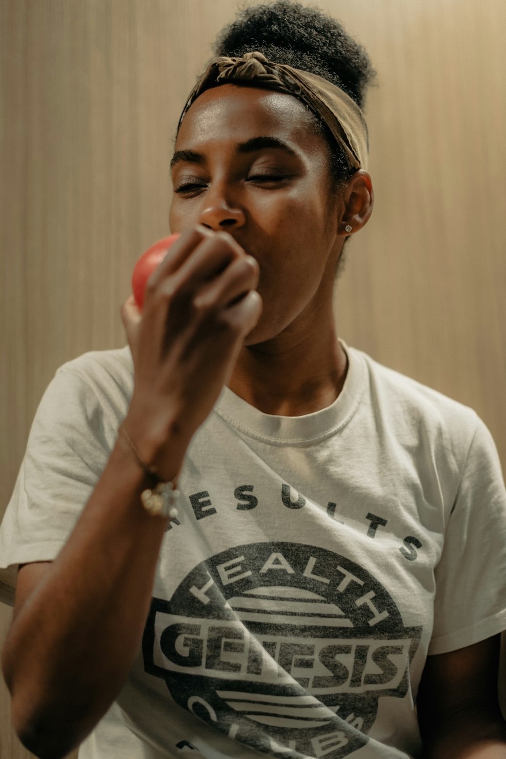 a woman is eating an apple in a room