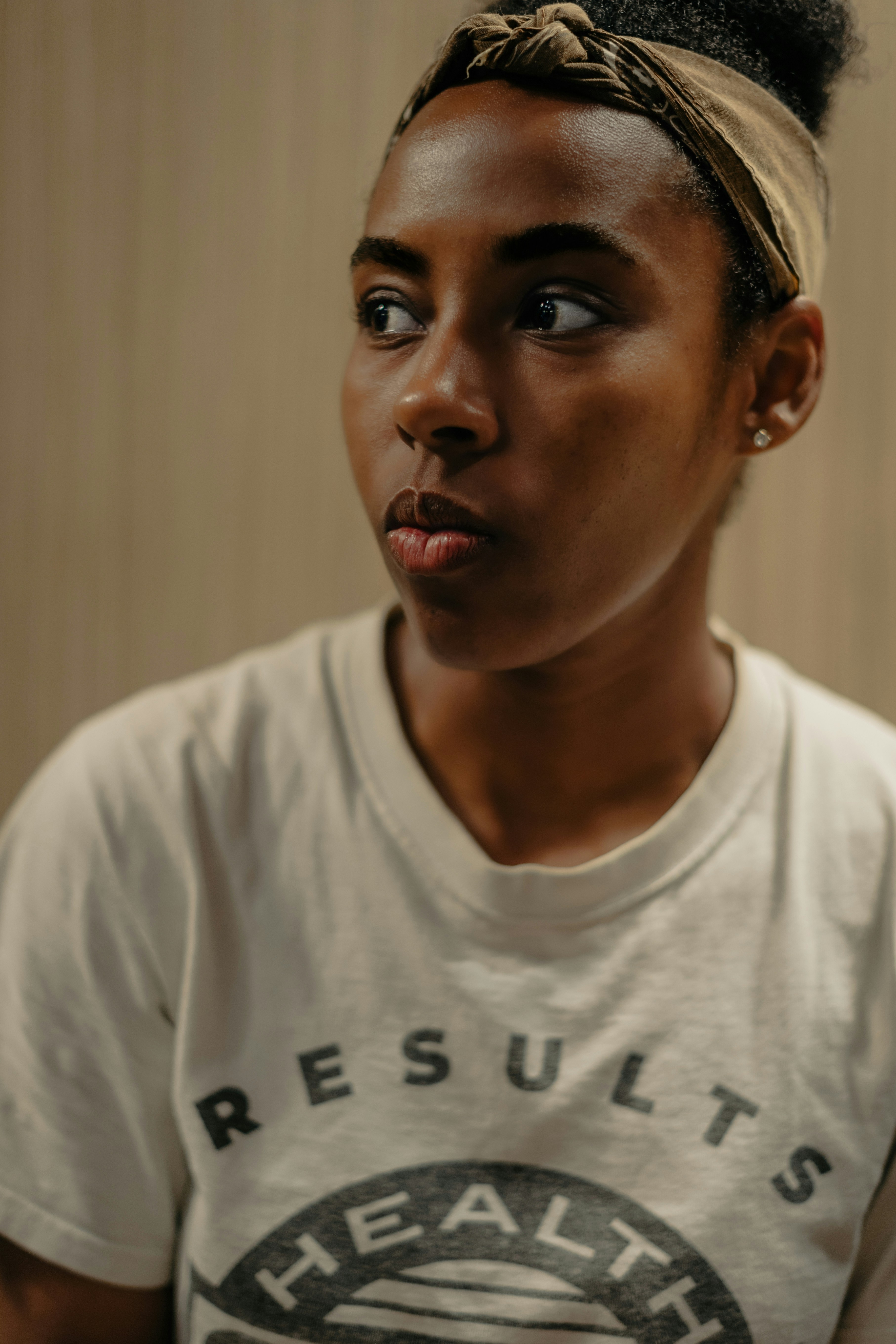 a woman in a white shirt holding a cell phone