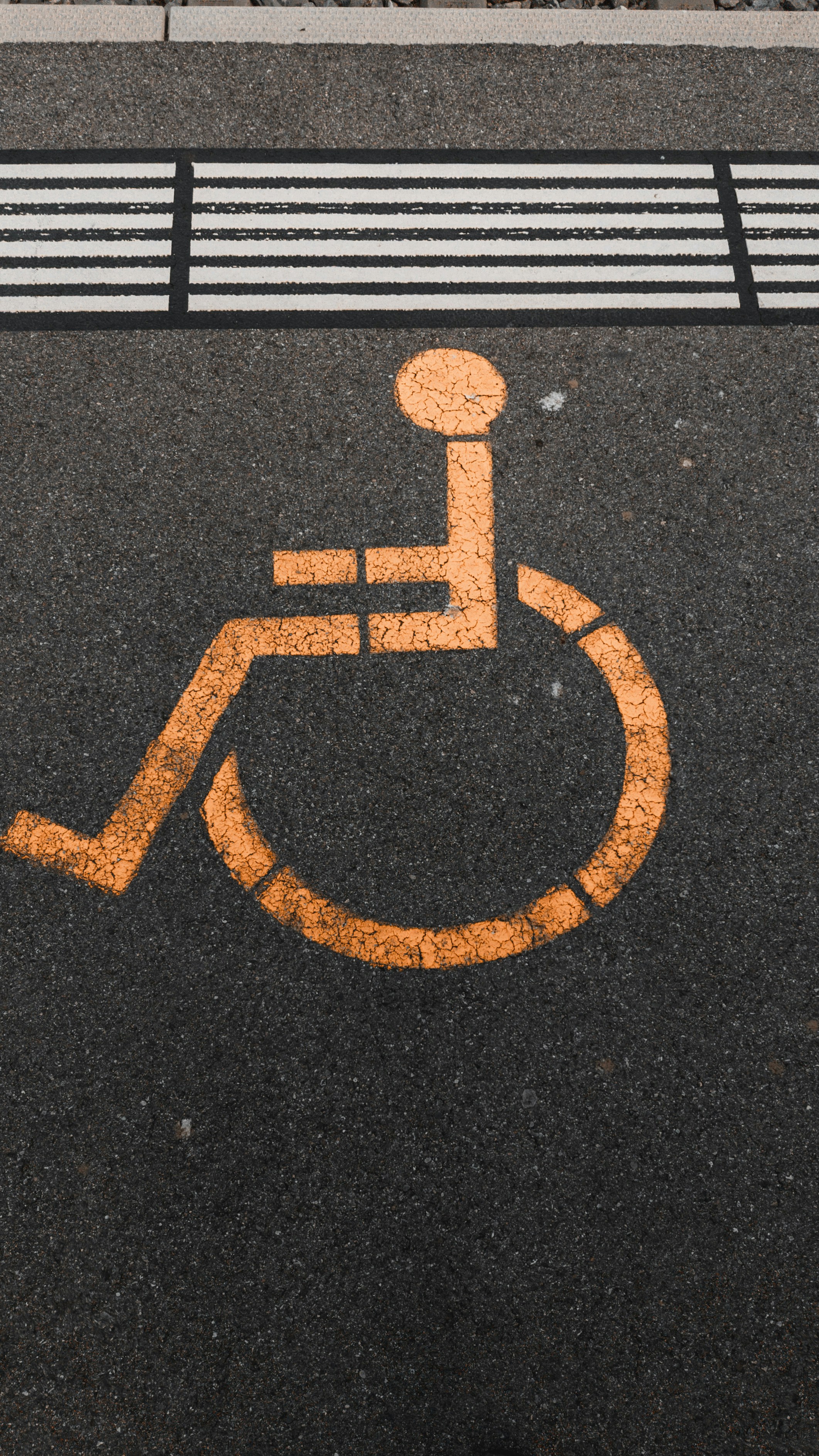 a handicap sign painted on the pavement of a street