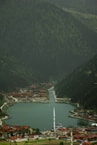 a large body of water surrounded by a lush green hillside