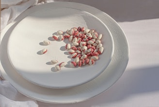 a white plate topped with red and white pills