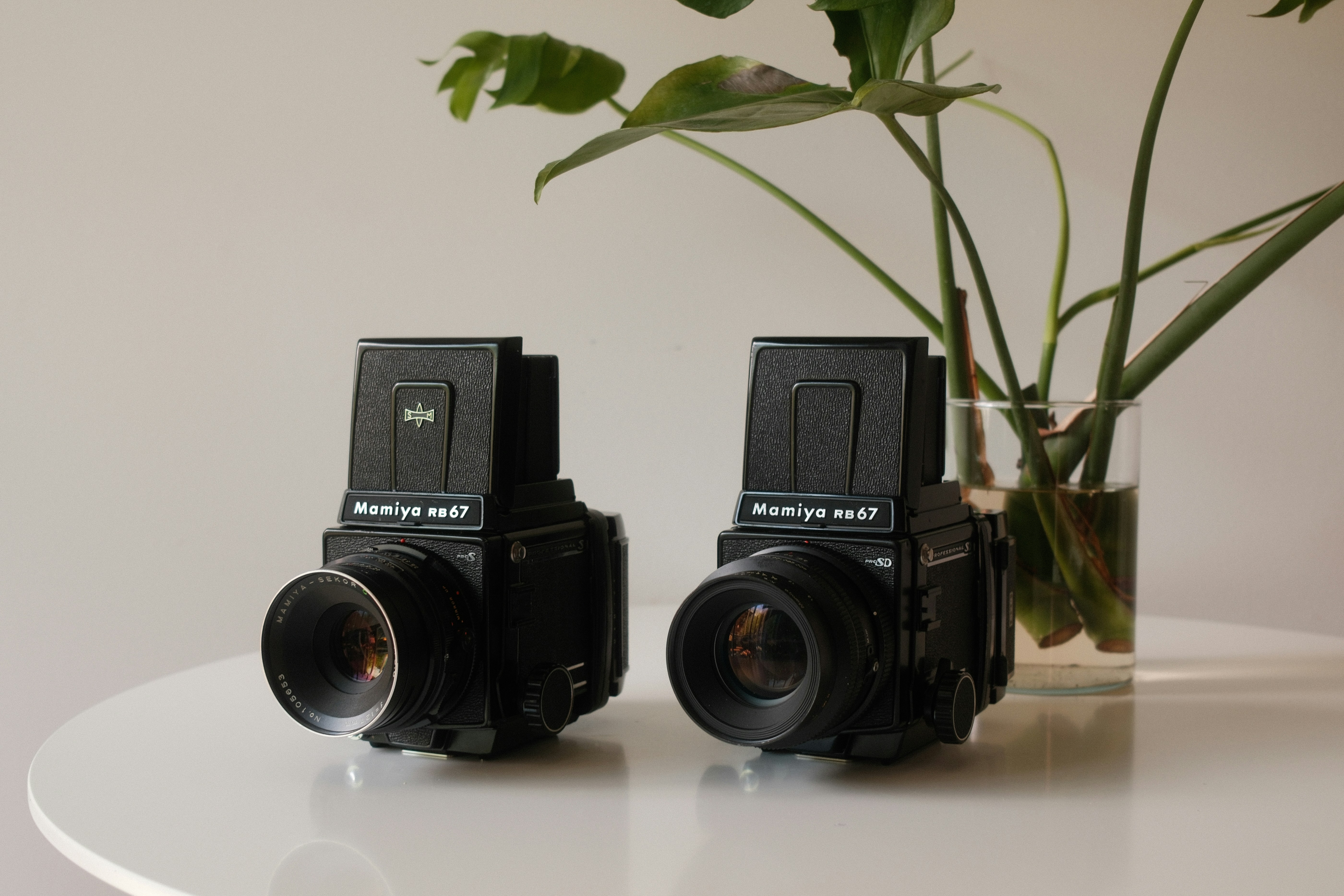 a couple of cameras sitting on top of a table