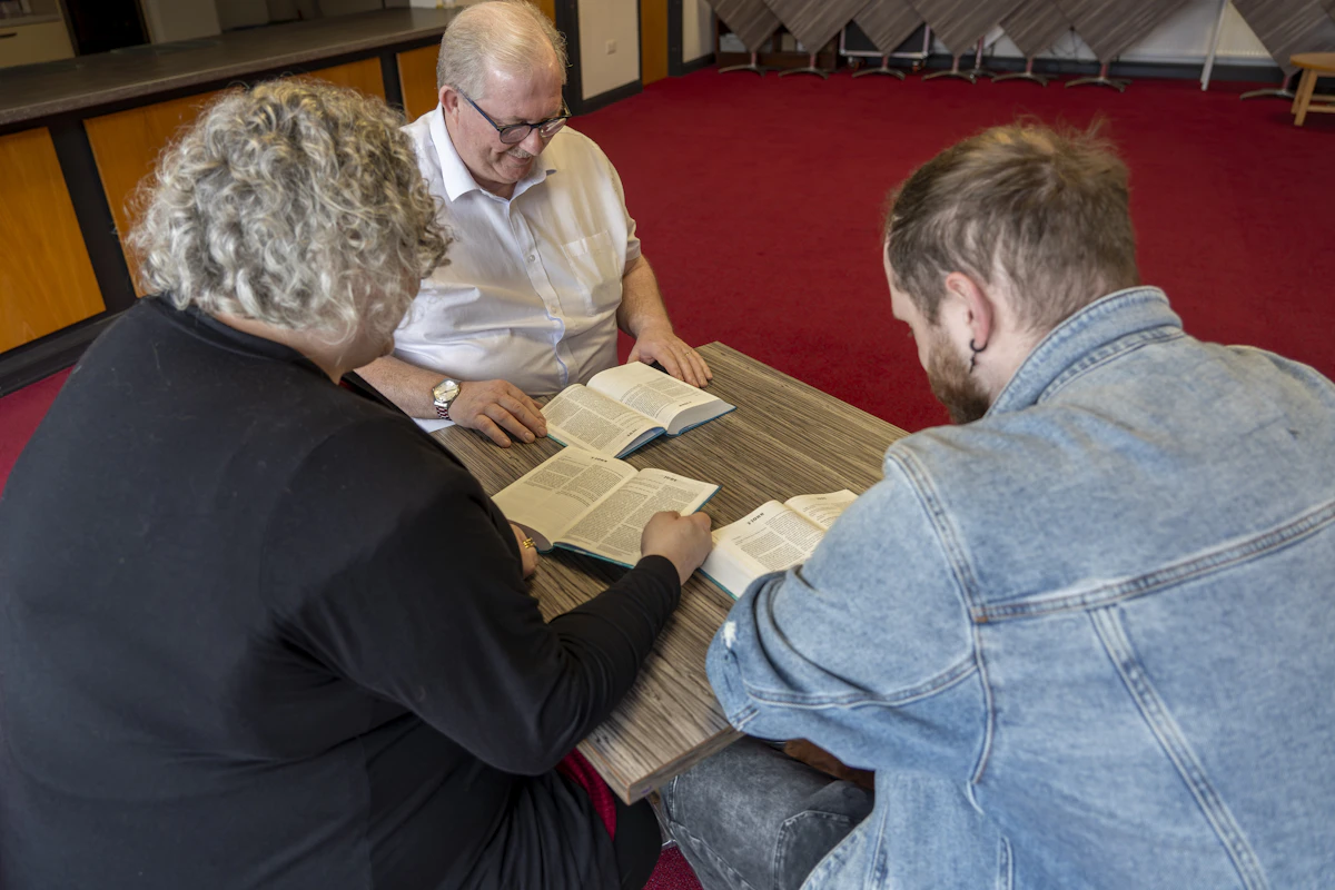 Group gathered for a church discussion around a table, representing church marketing and community outreach in Indianapolis
