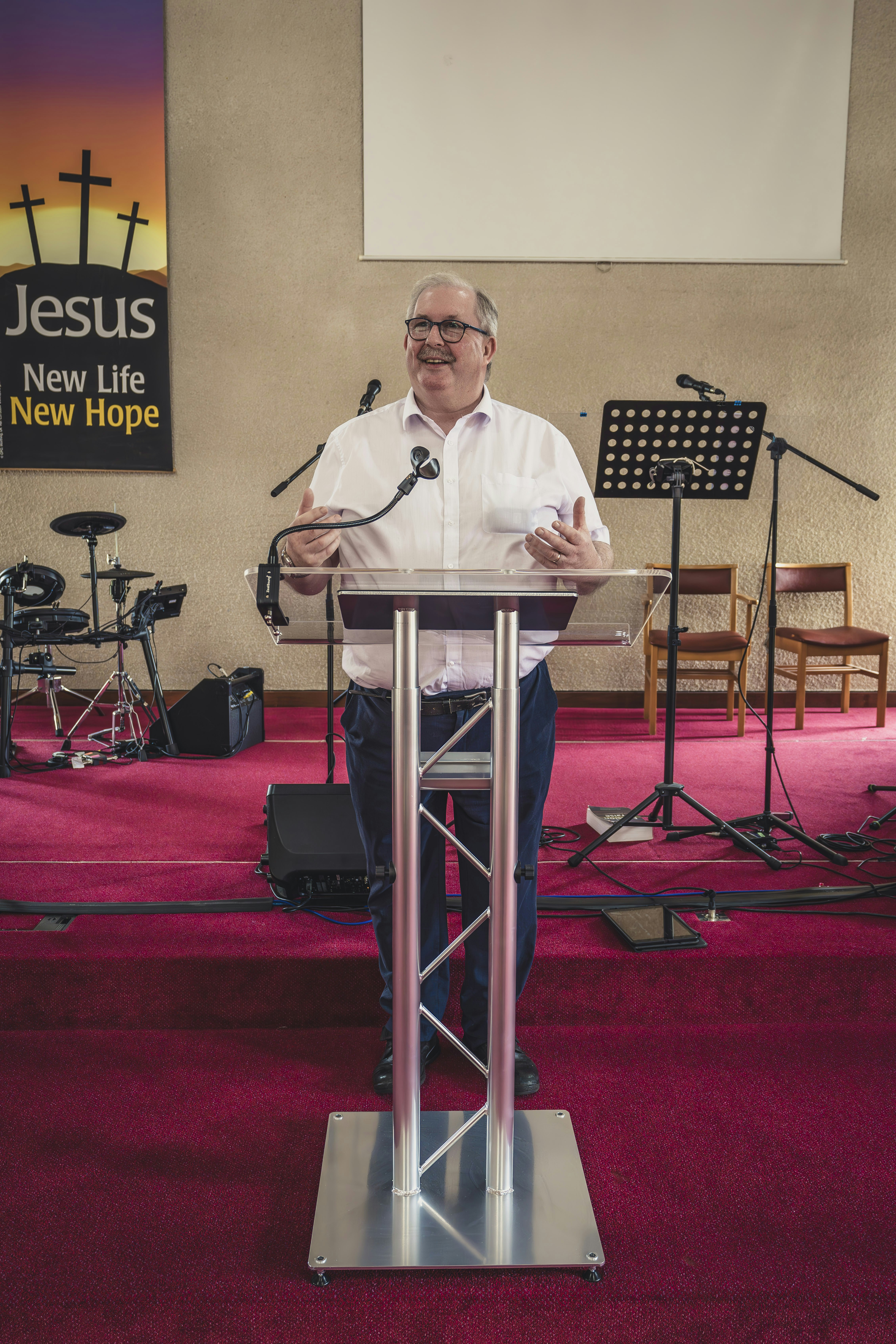 a man standing at a podium in front of a microphone