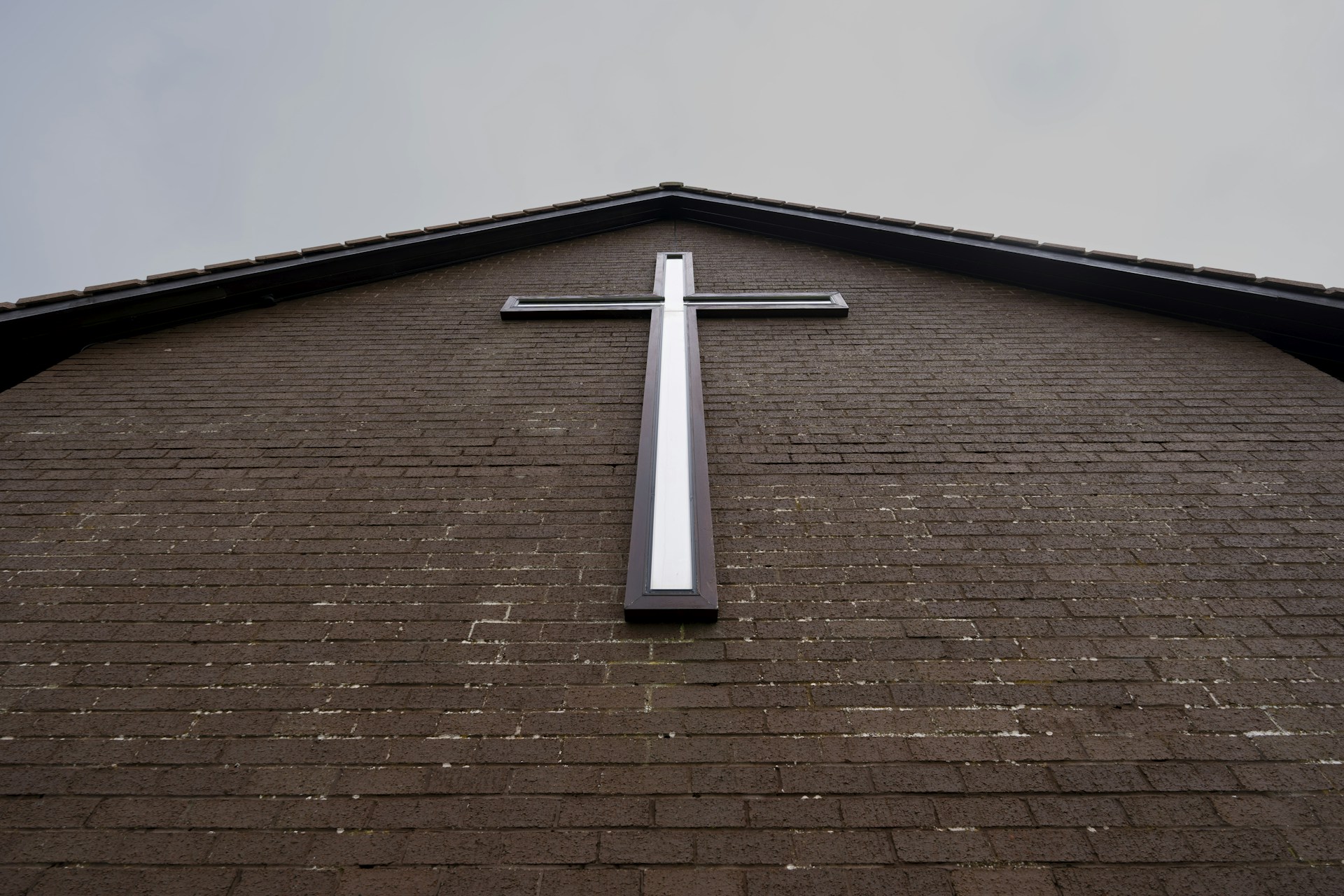 a cross on the side of a building