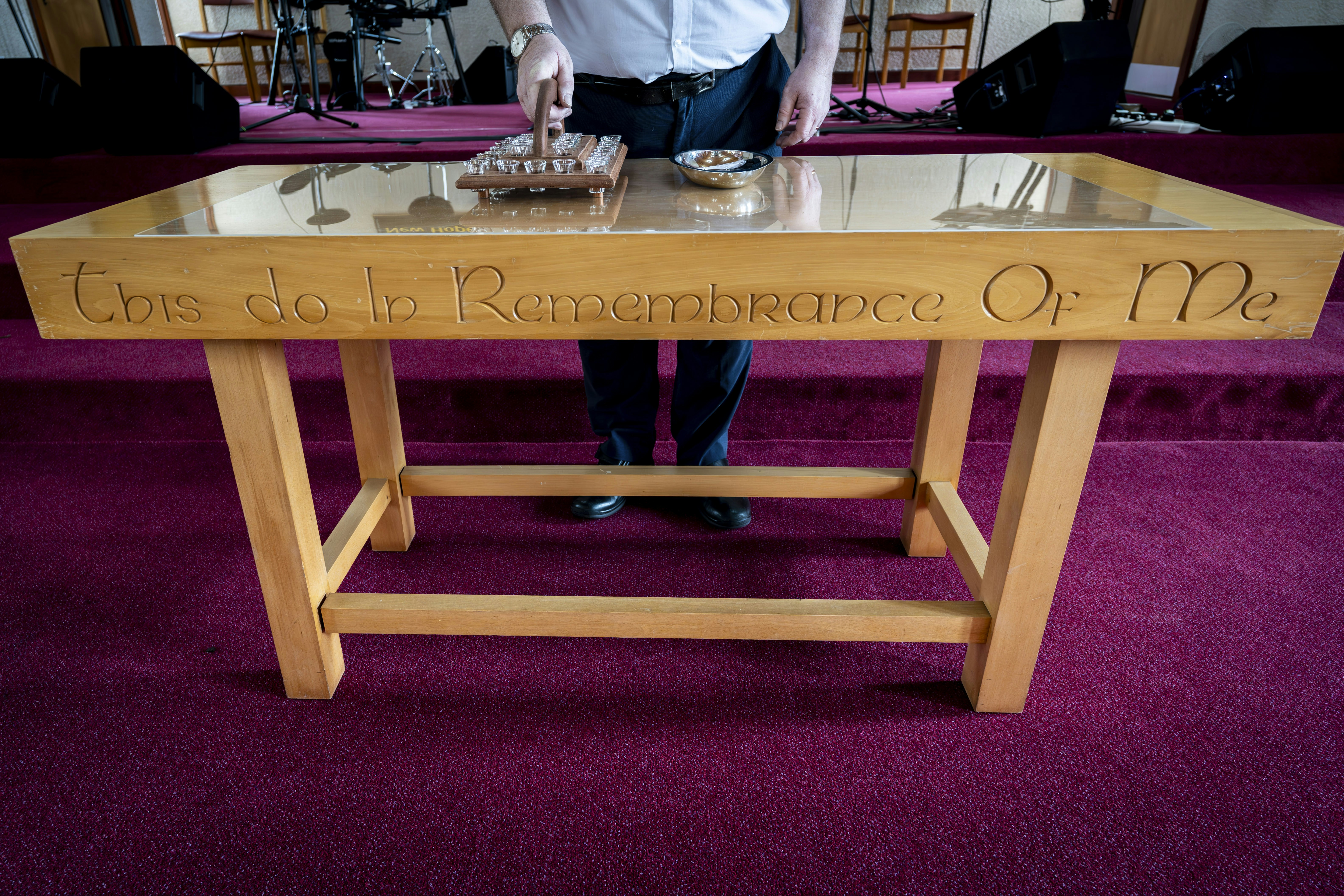 a man standing in front of a table with writing on it