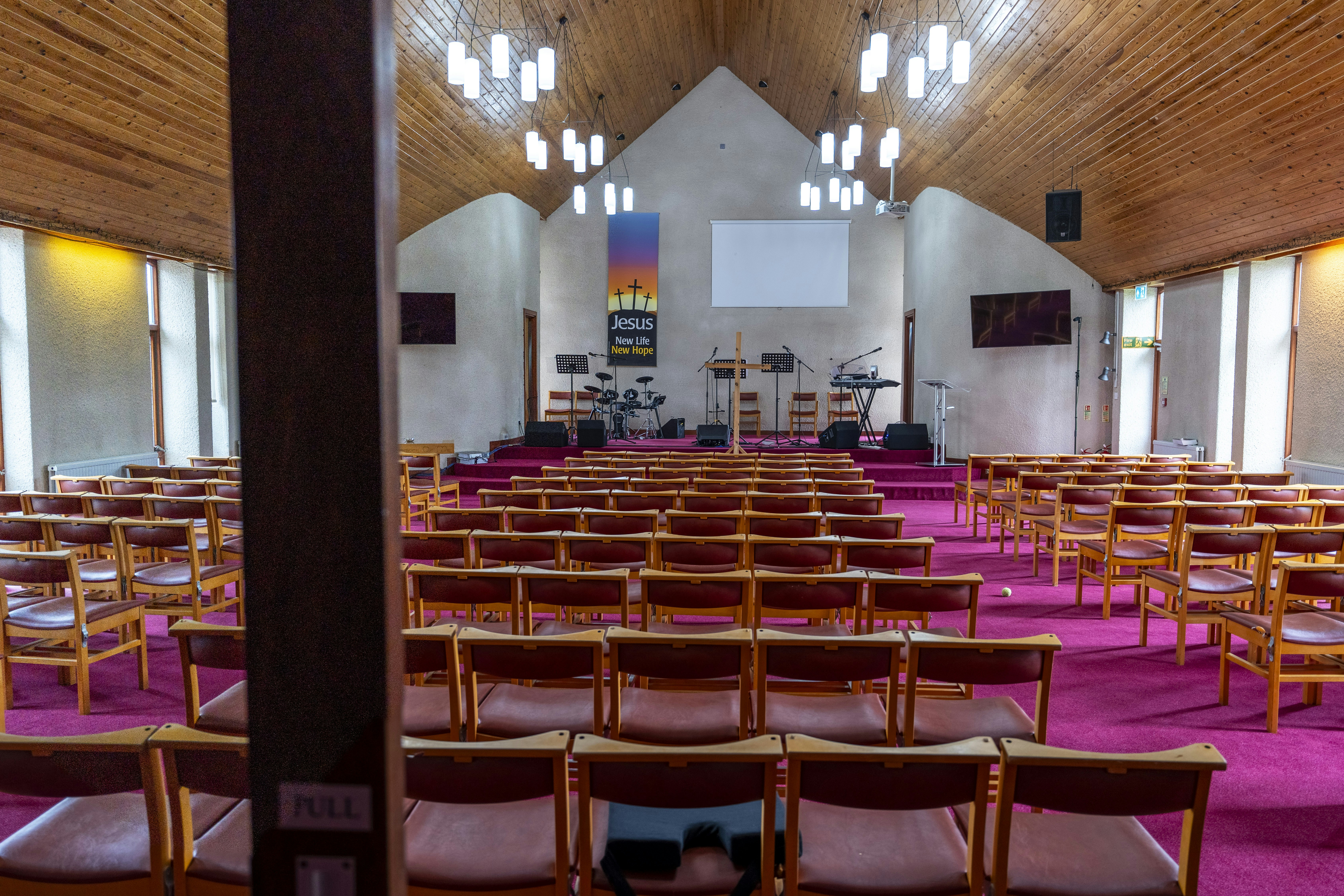 a church with rows of chairs and a stage