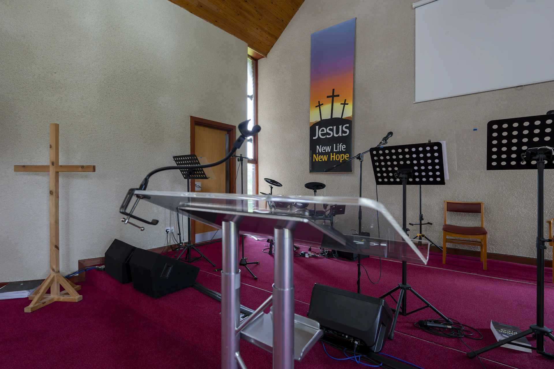 Church sanctuary with cross and musical equipment