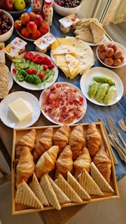 a table filled with plates of food and bowls of fruit
