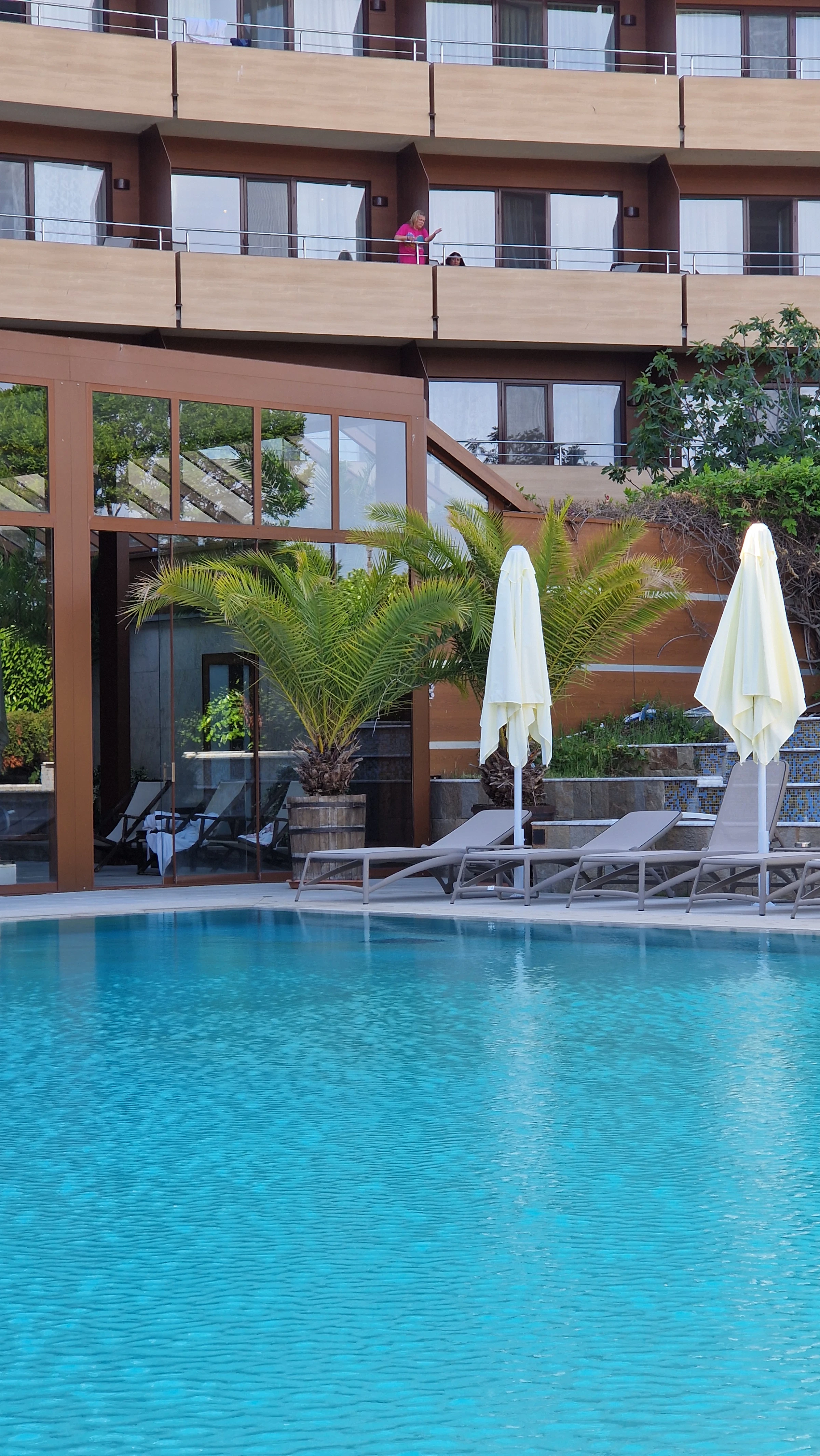 Resort pool deck with lounge chairs and umbrellas, elegant hospitality setting