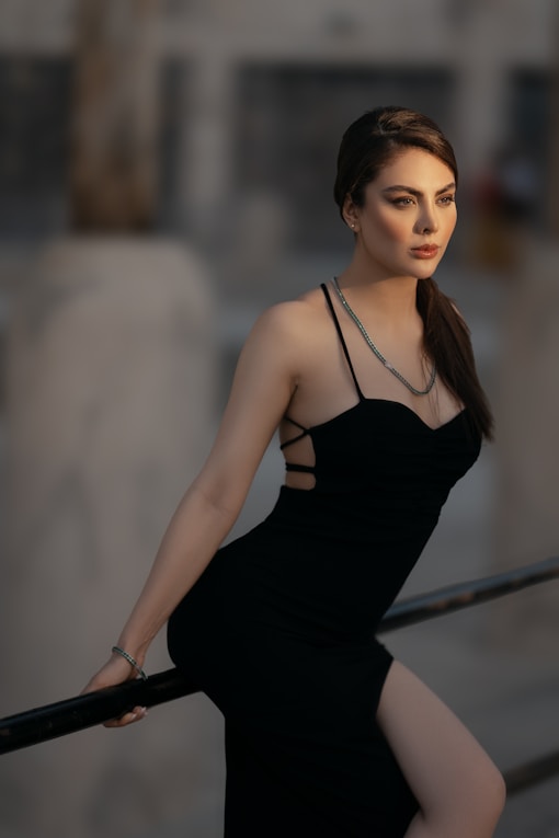 a woman in a black dress posing for a picture