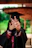 a woman in a graduation gown making a peace sign