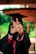 a woman in a graduation gown making a peace sign