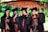 a group of people in graduation gowns posing for a picture