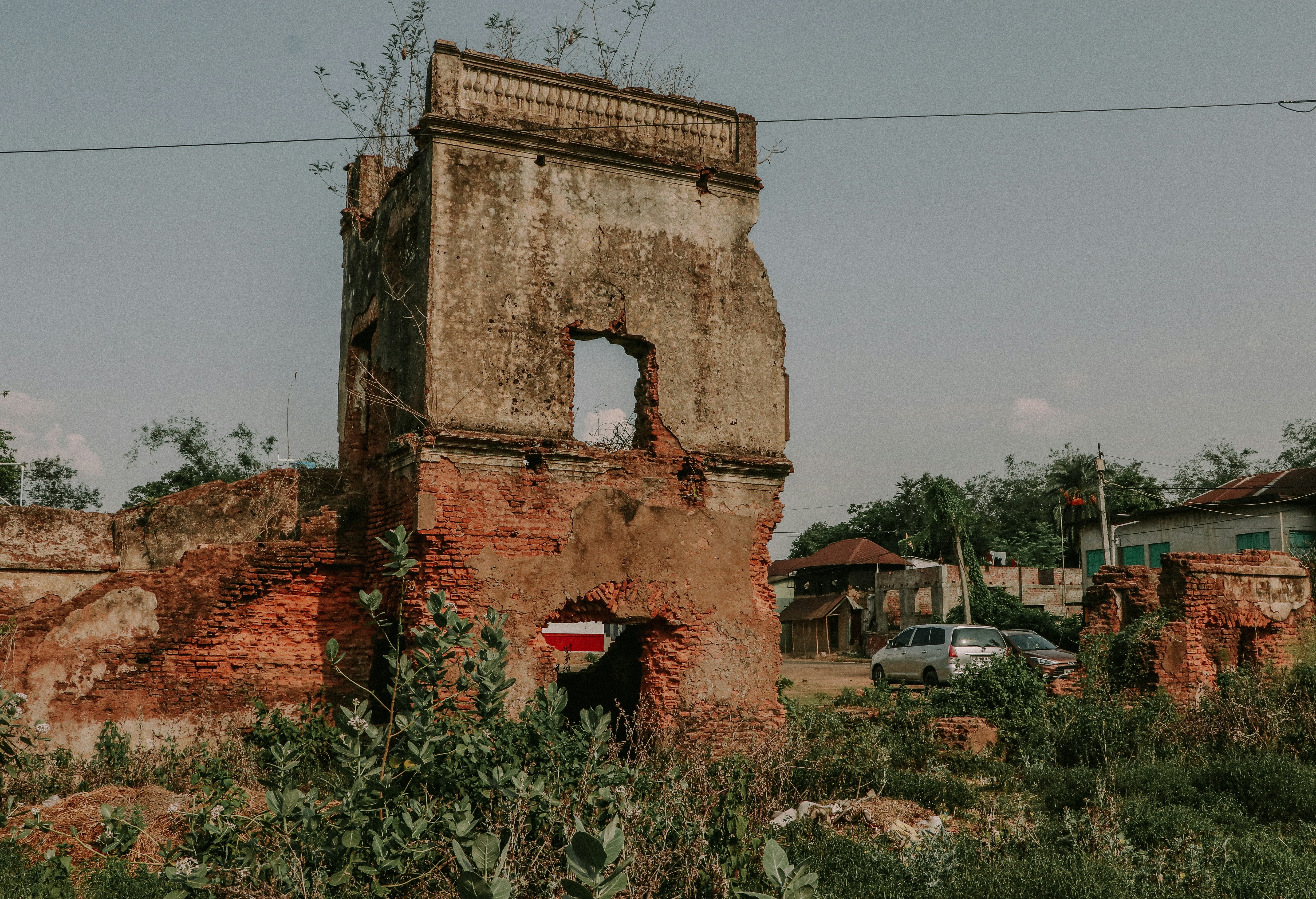 an old brick building with a broken window