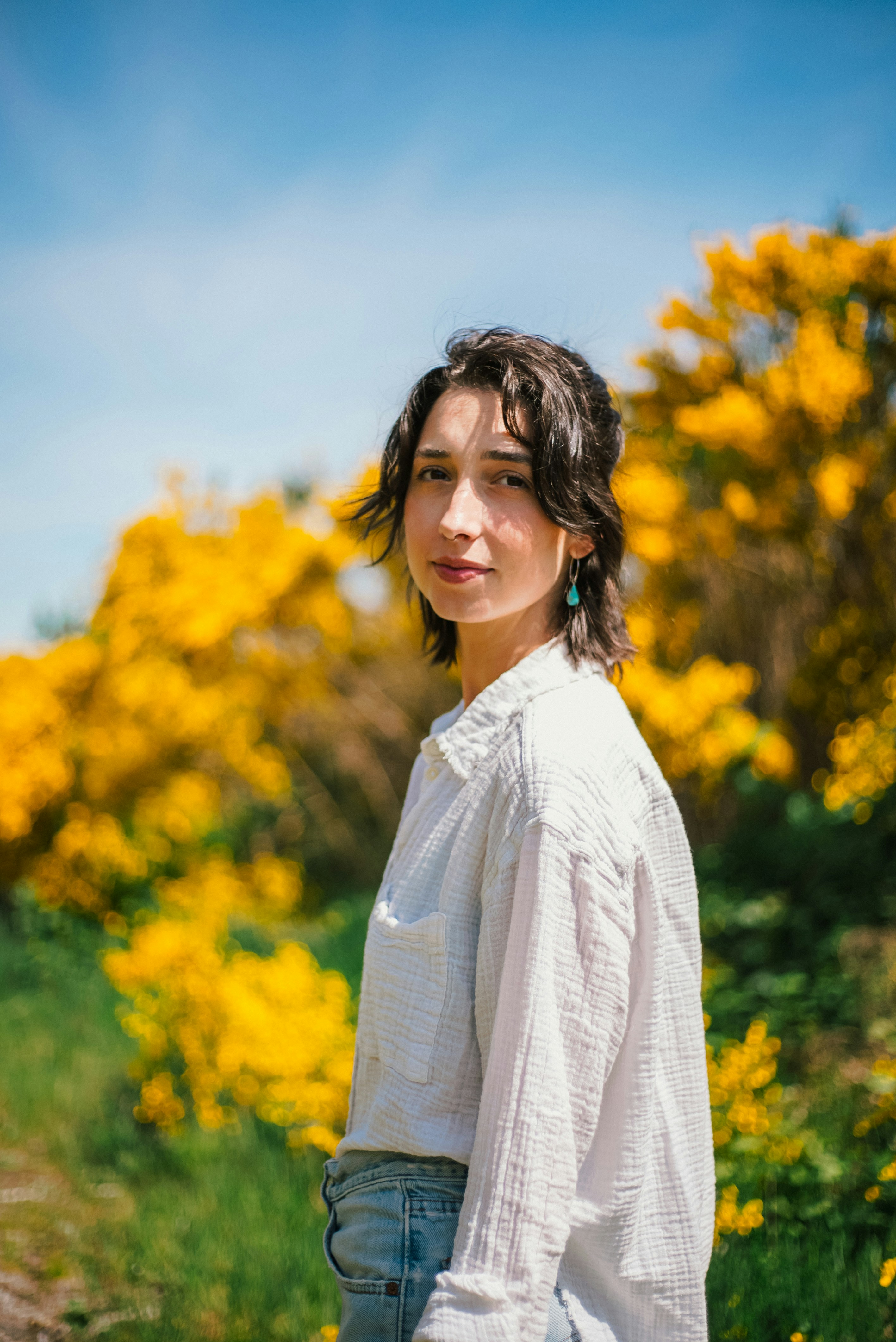 a woman standing in a field of yellow flowers