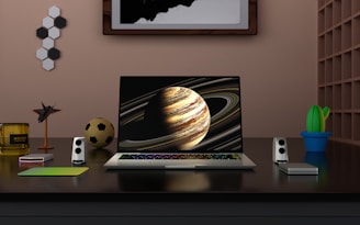 a laptop computer sitting on top of a wooden desk