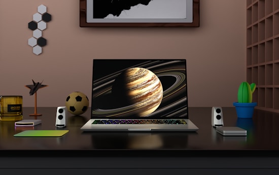 a laptop computer sitting on top of a wooden desk